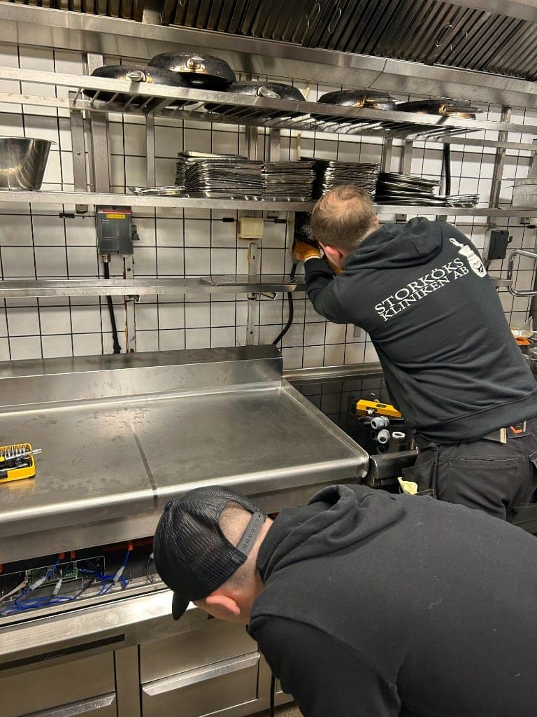 Två tekniker från Storkökskliniken servar utrustning i ett storkök